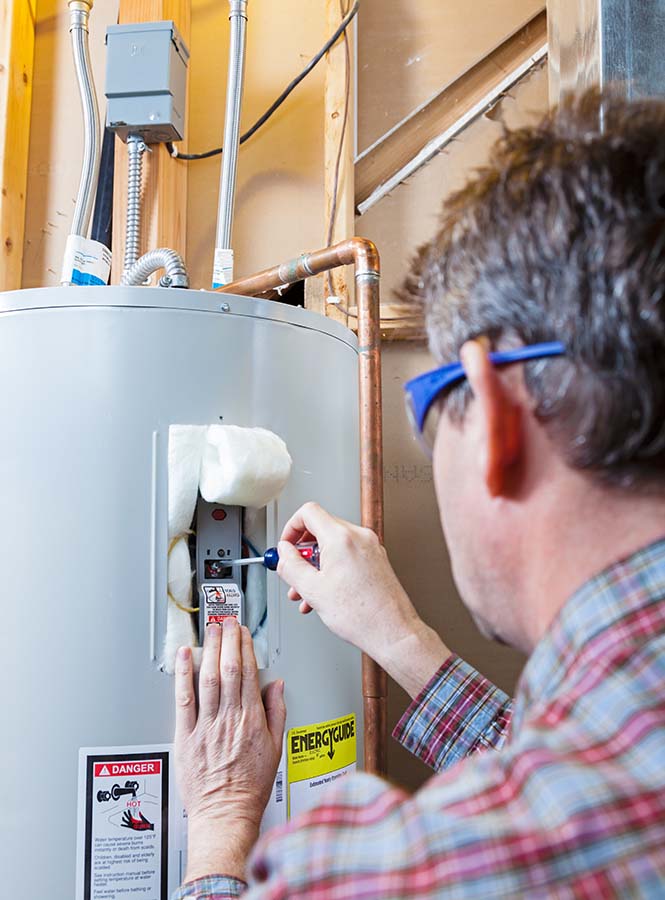 A man fixing a heater