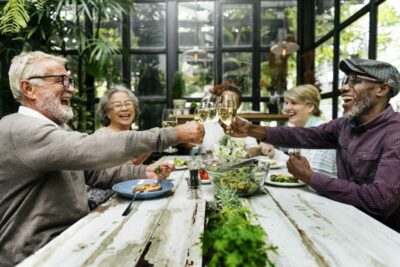 Older adults cheering over dinner