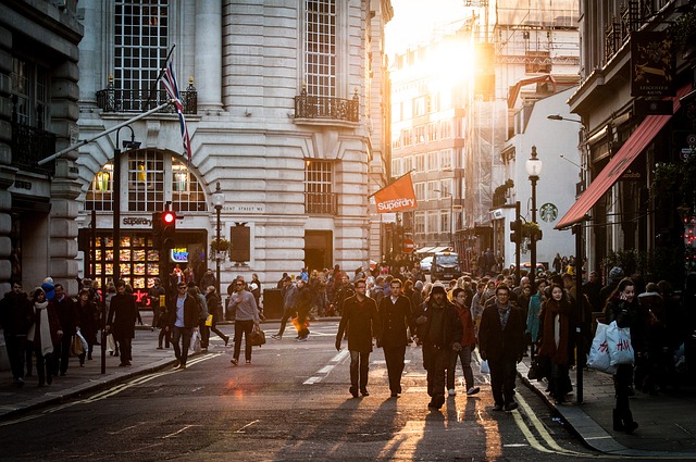 Lots of people walking in the city around evening